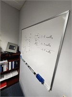 Dry erase board hanging on wall.