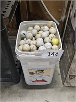 bucket of used golf balls