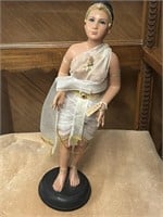 Doll figurine on stand