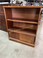 Wood bookcase with sliding doors.  38.5” H x