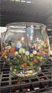 Damaged marbles in a large glass bowl