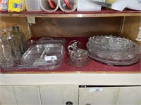 Shelf full of glassware serving pieces