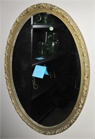 Mirror in oval golden frame
