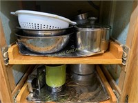 Pans and cookware in lower cabinet