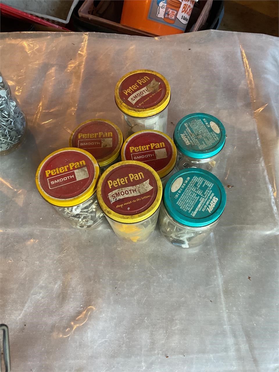 Vintage peanut butter jars full of screws etc