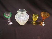 Four items that glow: three wine goblets, one is
