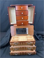 Two wooden ladies jewelry boxes. The tallest box