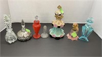 Various perfume bottles, one doesn’t have topper,