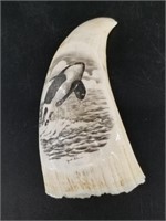 Yvec Sha? Scrimmed sperm whale's tooth depicting b