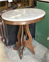 Oval marble top table on a pedestal style base