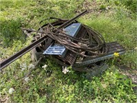 Scrap pile with cable, ramps and cinder blocks.