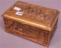 An ornate brass jewelry casket decorated