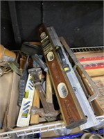 assorted tools including hammers axes levels and