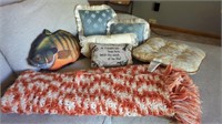 VARIETY OF PILLOWS AND AN ORANGE AFGHAN