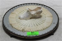 Pedestal mirror, doily and ceramic shoe