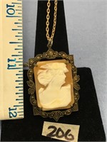 1 1/2" cameo pendant, art deco on a gold colored c
