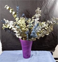 Large purple vase with eucalyptus branches.