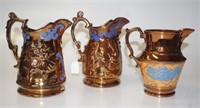 Group three antique copper lustre table jugs