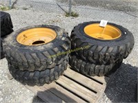 E4 new10-16.5 skid steer tires on NH/JD/CAT wheels