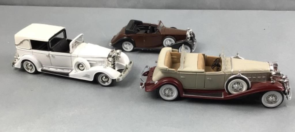 3 model cars  rear bumper on tan colored car