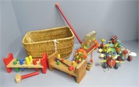 Wicker basket filled with vintage wood pull toys