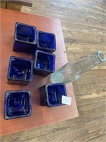 Six cobalt blue, candleholders and vintage bottle