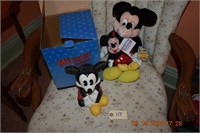 Mickey Mouse bank and 2 stuffed mickeys.