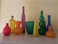 Box of brightly colored vases