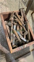 Wood box of railroad rail spikes. Nails are 5 to