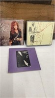 Autographed: Bonnie Rait CD; Eric Clapton CD