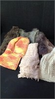 Muted toned scarves and knitted hats