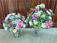 Pair of floral arrangements in vases. 1 floral