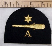 FELT PATCH WITH STAR OVER CANNON OVER "Q"