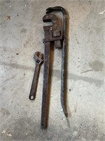 Two adjustable wrenches and pry bar