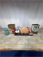 Assortment of tins, motor oil cans, and glass jar