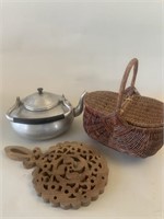 Aluminum teapot, covered basket, wood trivet