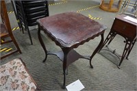 antique mahogany parlor table with carved corners,