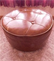 Round leather ottoman on casters, 24" x 13"