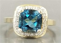 14k gold ring set with blue topaz and diamond
