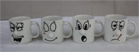 Four sculpture face mugs