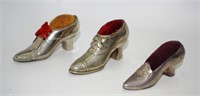 Three vintage metal shoe form pin cushions