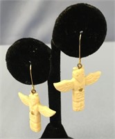 A pair of totem pole ivory earrings with small gol