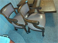 Two vintage rolling office armchairs