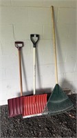 Two snow shovels and a plastic rake