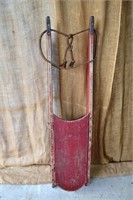 Old painted wood sled with iron runners entitled T