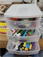 Pencils, tape, erasers in storage drawer