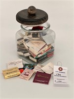 Glass jar with collection of match books and boxes