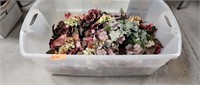 Tote of artificial flowers and greenery