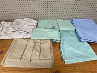 Assortment of used bed linen and sizes . Flat