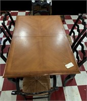 Wooden dining table & 6 ebony chairs w rush seats